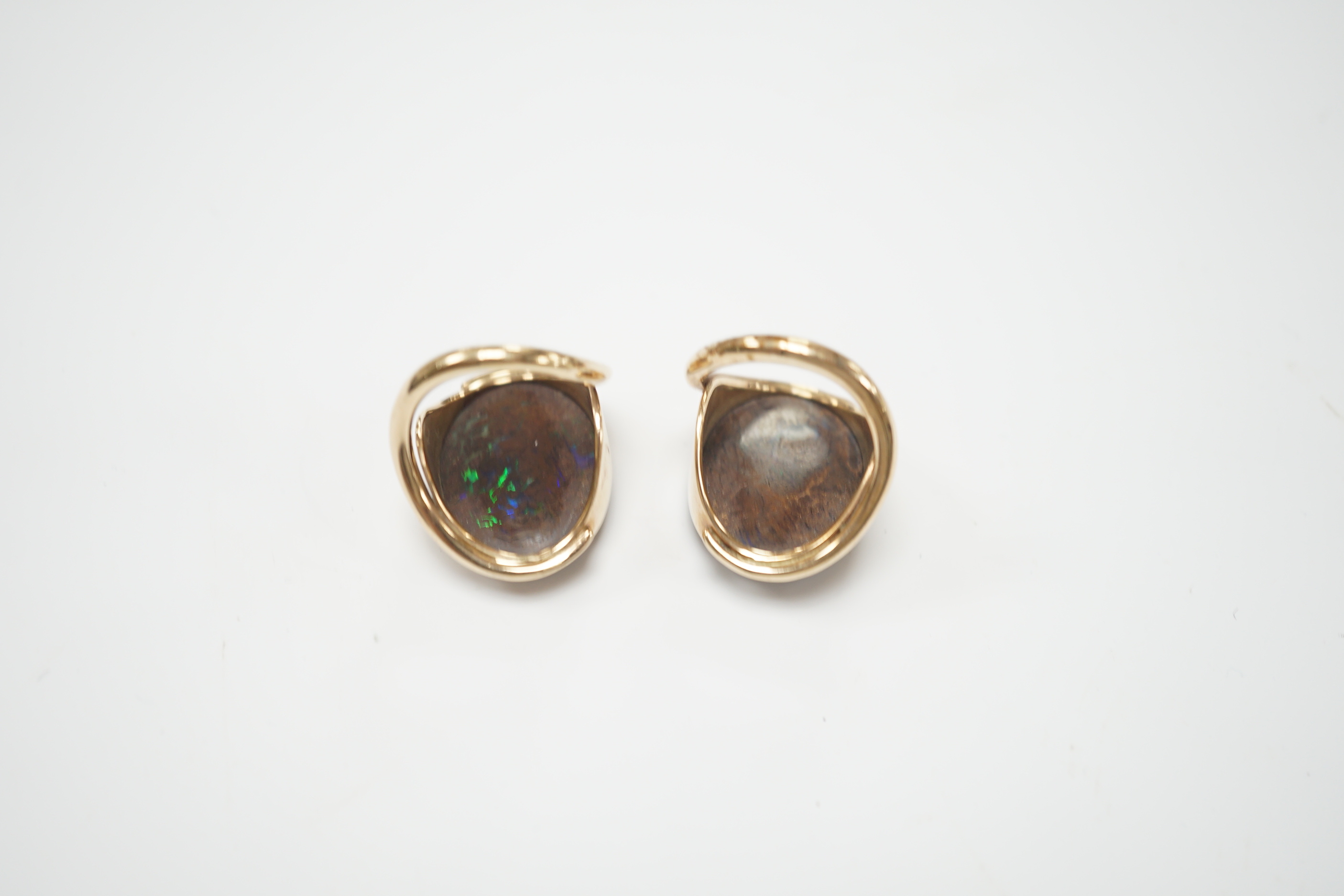 A pair of yellow metal and oval boulder opal set dress rings, both size M, gross weight 20 grams.